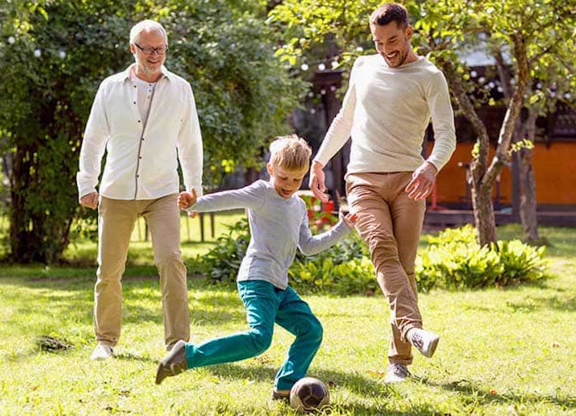 Family playing football outdoors